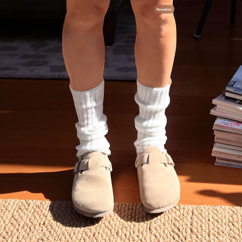 Ivory ribbed leg warmers worn with beige clogs, front view