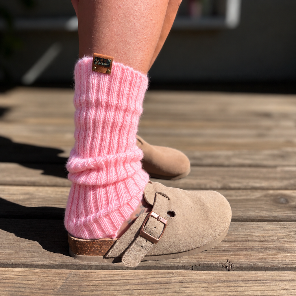 Candy pink ribbed leg warmers worn with beige clogs