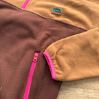 Close-up of the fuchsia zippered pocket on the Toffee fleece pullover