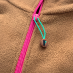 Close-up of the fuchsia zipper and turquoise Peek Breeze pull on the Toffee fleece