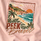 Close-up of the tropical beach print on the back of the pale pink Coastal crewneck