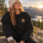Woman wearing the black ROAM crewneck outdoors in the mountains