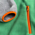 Close-up of the zippered side pocket with green fleece and lavender sherpa on the Aspen dress
