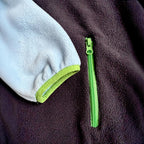 Close-up of the zippered side pocket on the Seaside fleece dress with navy fleece and lime trim