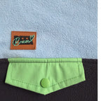 Close-up of the lime-green snap chest pocket and Peek Breeze label on the Seaside fleece dress