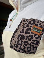Close-up of the leopard chest pocket and half-zip on the Savana fleece dress