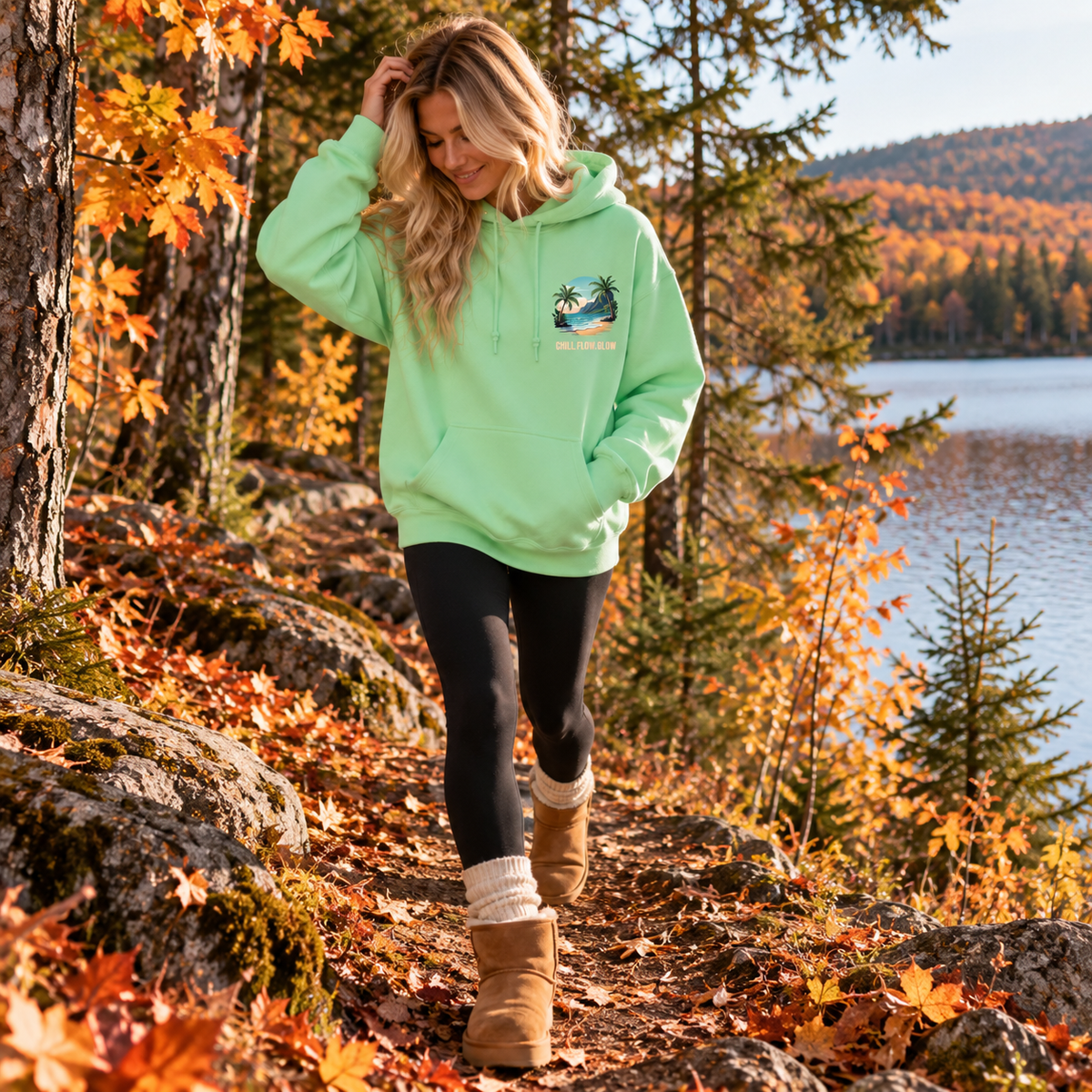 Woman wearing the mint Aloha hoodie in nature in the fall