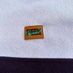 Peek Breeze logo patch on soft lilac fleece above the navy panel