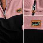 Close-up details of the black quarter-zip, logo zipper pull and Peek Breeze patch on dusty rose fleece