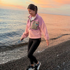Woman wearing the Boreal pink fleece pullover with corduroy details by the sea