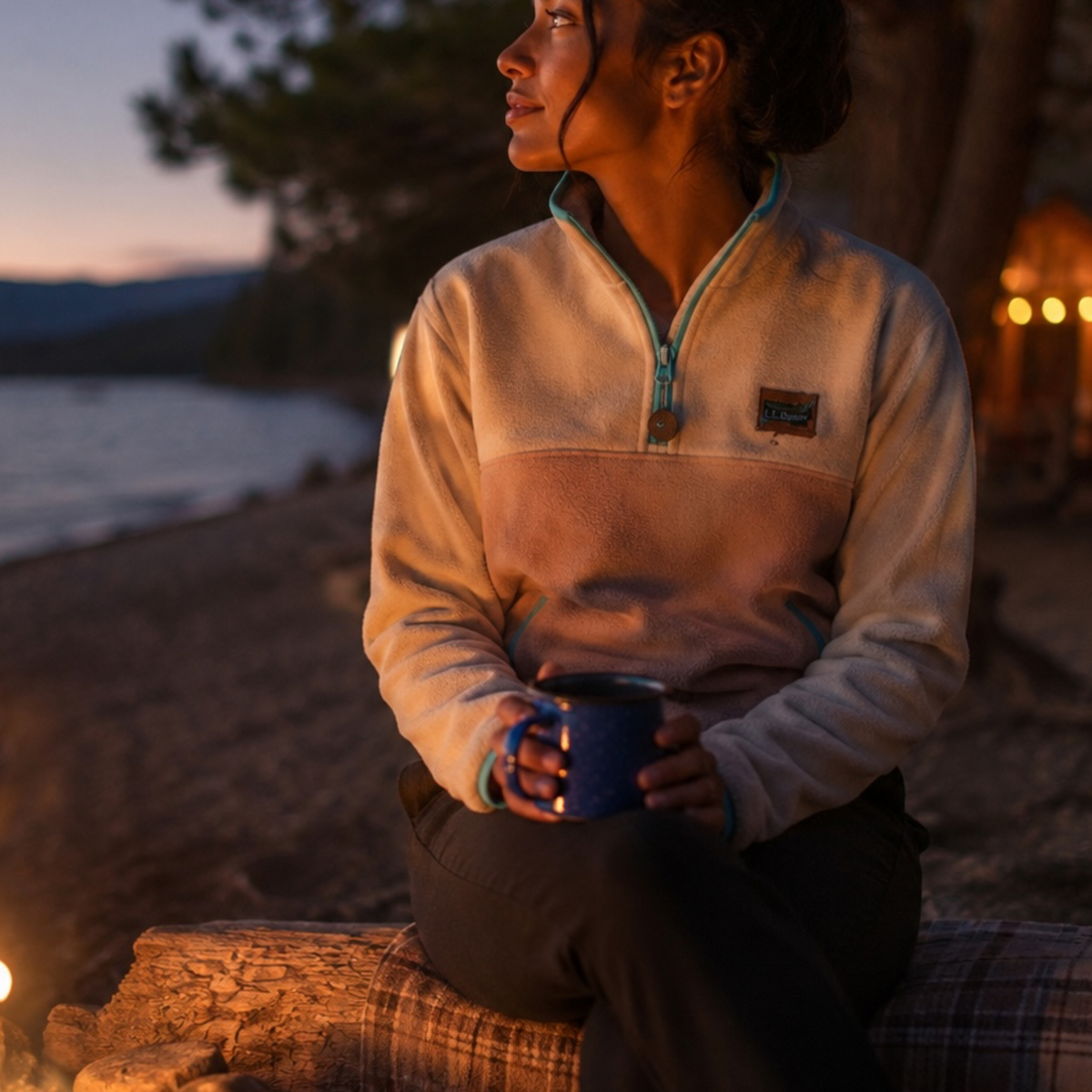 Woman wearing the Oasis ivory and sand fleece pullover by the water