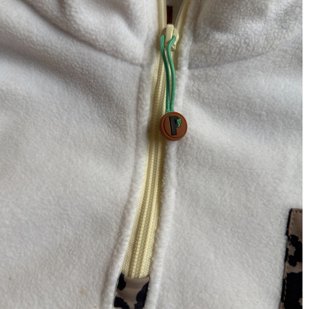 Close-up of the half-zip with turquoise pull and Peek Breeze logo on the Savana fleece dress