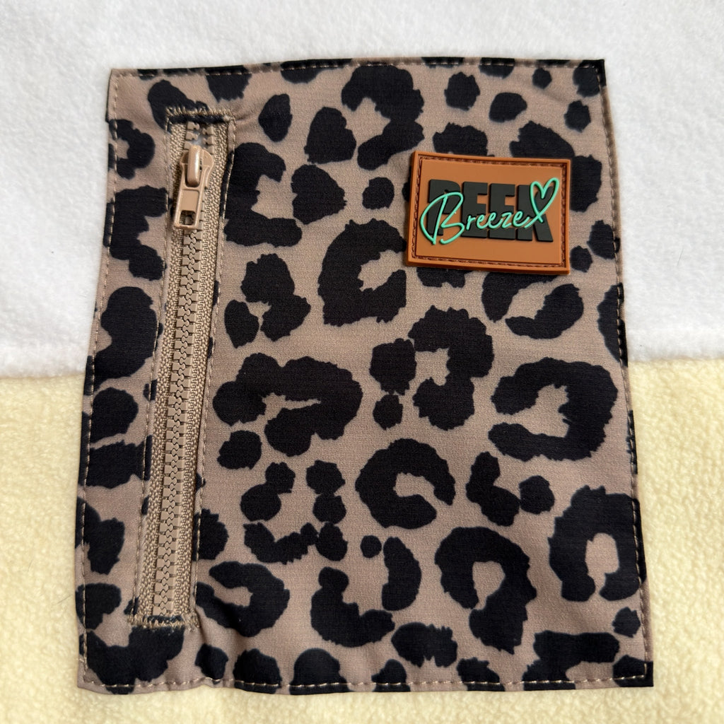 Close-up of the leopard print zippered chest pocket and brand label on the Savana dress
