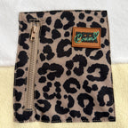 Close-up of the leopard print zippered chest pocket and brand label on the Savana dress