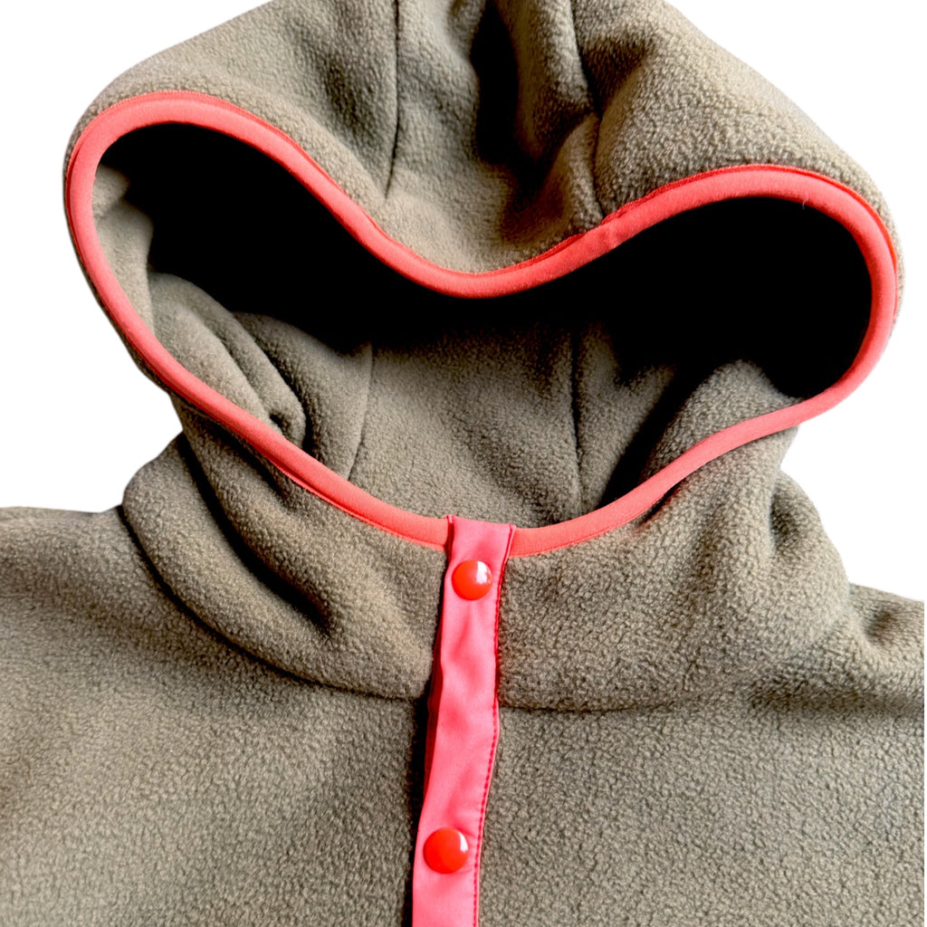 Close-up of the khaki collar with coral trim and pink snaps on the Retro fleece dress