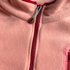 Close-up of the stand collar with zipper and turquoise logo pull on the Rosie fleece dress