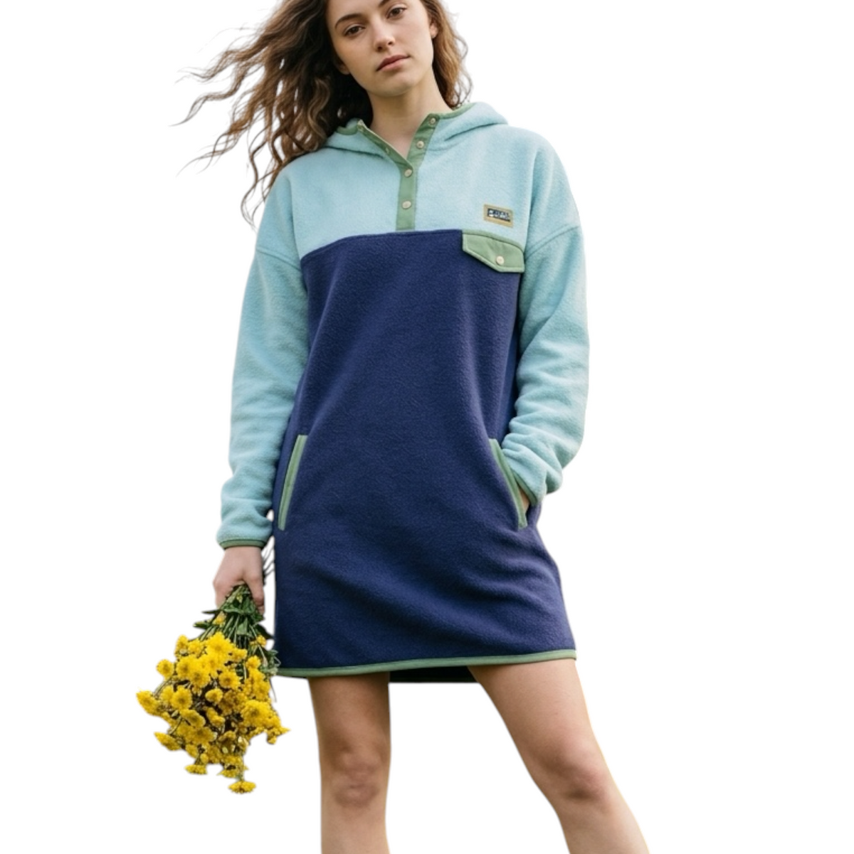 Woman wearing the Seaside hooded fleece dress in light blue, navy and sage green on a light background