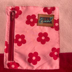 Close-up of the floral print zippered chest pocket and Peek Breeze label on the Rosie fleece dress