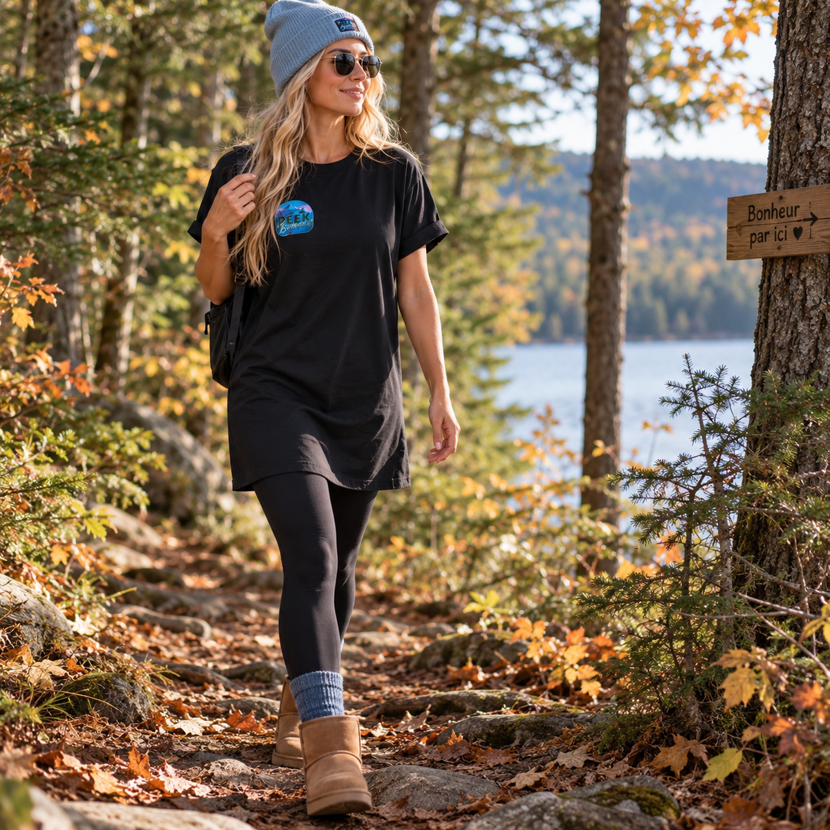Black Nomad T-shirt dress worn with leggings and boots on a forest trail